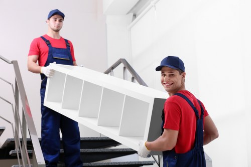 Professional movers handling stairs during a Bermondsey flat removal