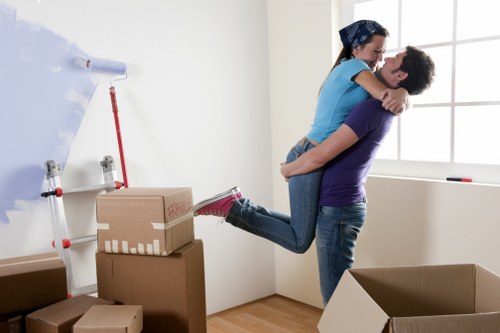 Boxes and furniture being moved through a Bermondsey apartment corridor